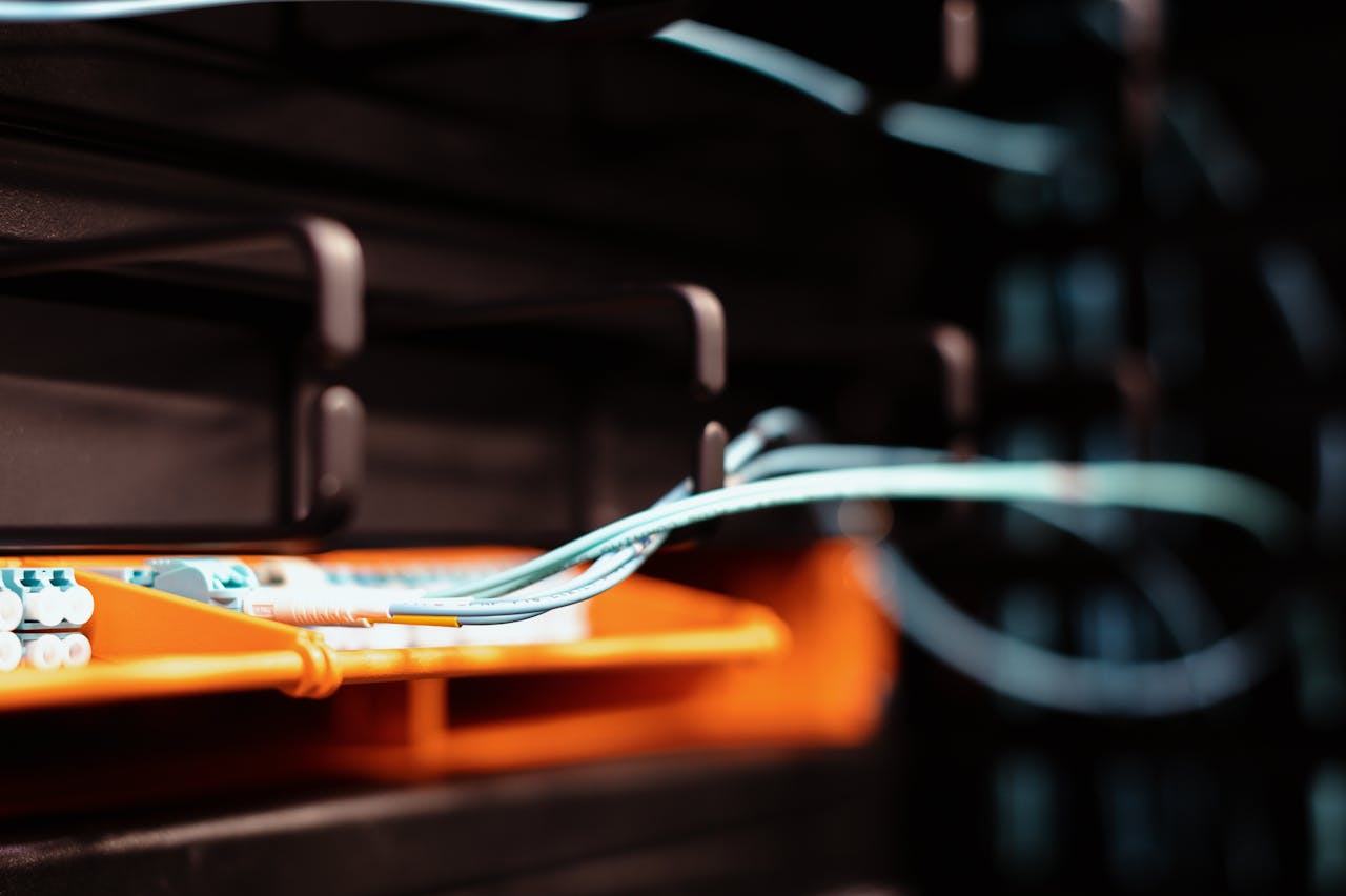 Home Blue wires connected to contemporary electronic equipment with multiple inputs on blur background